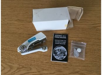 Vintage Bluebird AX-3 Hand Held Sewing Machine With Original Directions And Accessories In Original Box.