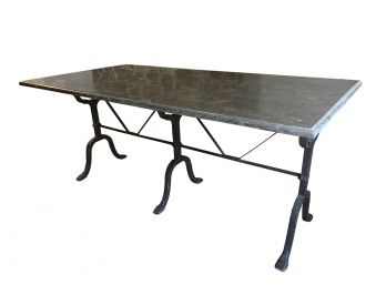 Stone Look Slab Dining Table With A Forged Iron Trestle Base