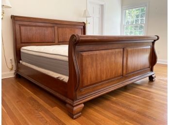 A Solid, Paneled Hardwood King Sleigh Bedstead
