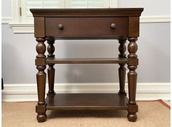 A Hardwood Nightstand With Turned Legs