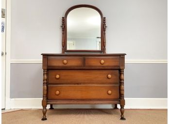 A Hardwood Mirrored Dresser With Turned Legs