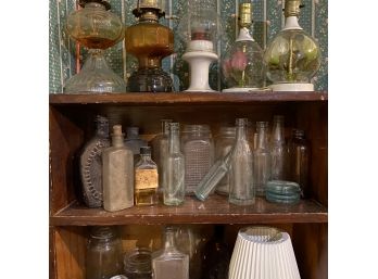 Small Wooden Shelf With Contents Bottles Lamps And More