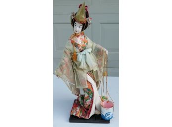 Vintage Geisha Girl Doll In  Patterned Kimono With Gold Hat And A Bucket