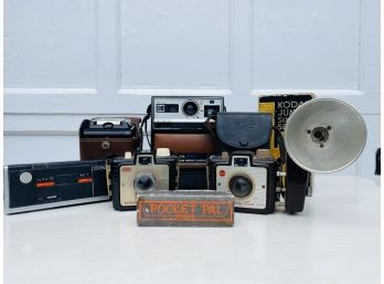 Collection Of Vintage Cameras And Pocket Harmonica