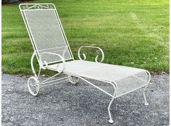 A Vintage Wrought Iron And Mesh Lounge Chair