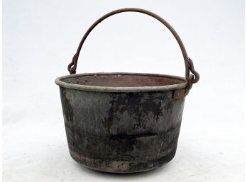 An Immense Copper Cauldron With Cast Iron Handle