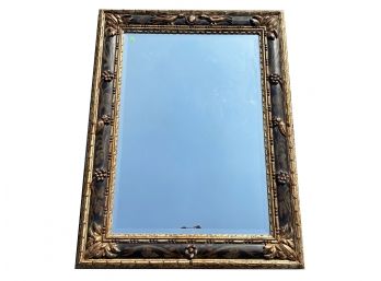 A Large Ornately Framed Beveled Mirror