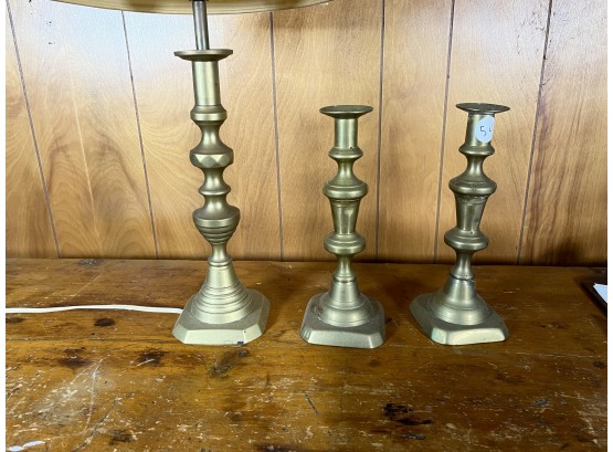 THREE ANTIQUE PUSH UP CANDLESTICKS, ONE CONVERTED TO LAMP