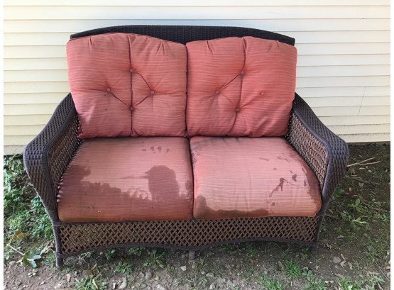 Dark Brown Outdoor Wicker Loveseat With Burnt Orange Stried Sunbrella Cushions