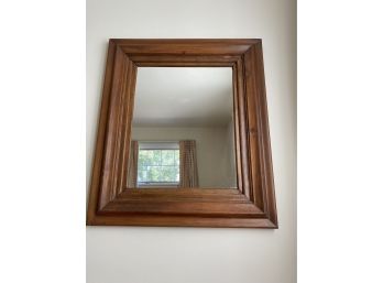 An Antique Wood Framed Mirror