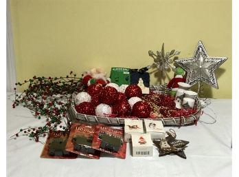Group Of Christmas Decorative Items In A White Basket With Red And White Round Ornaments And More