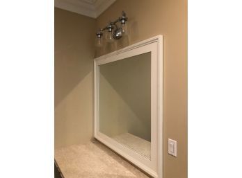 A Large White Wood Frame Mirror