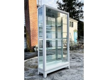 A Large, Modern Glass Sliding Door Curio Cabinet From Home Meridian