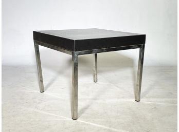 A Modern Chrome And Ebonized Wood Tone End Table