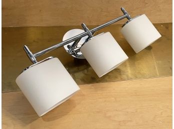 A Modern Vanity Light In Chrome With Frosted Glass Shades