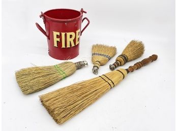 A Vintage Fire Bucket And Straw Brooms