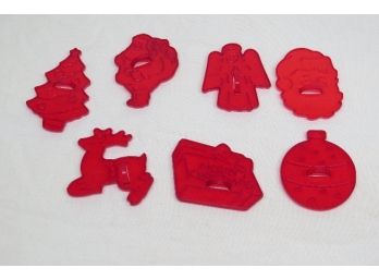 A Grouping Of Translucent Red Plastic Holiday Cookie Cutters