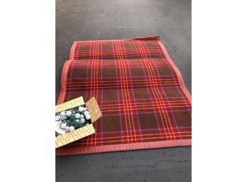 A Wool Plaid Area Rug With Leather Binding