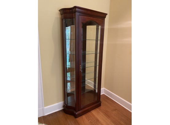 A Colonial Cherry Single Door Lighted Curio Cabinet With Five Glass Shelves By Jasper Cabinet Co