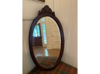 An Oval Ornate Beveled Mirror By Bombay Co.
