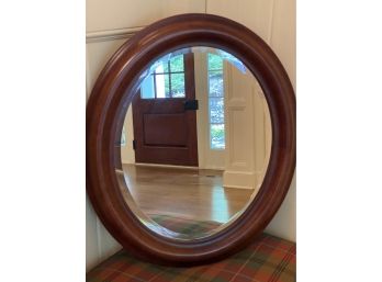 A Vintage Oval Wood Frame Beveled Mirror