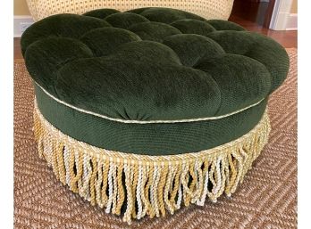 A Tufted Round Ottoman With  Fringe