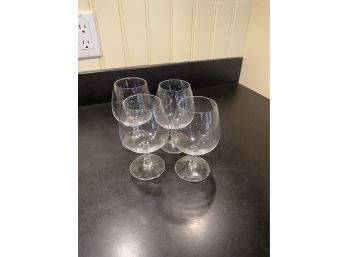 A Set Of Four Footed Wine Glasses