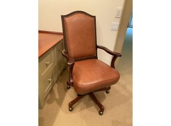 A Classic Wood And Leather  Executive Desk Chair On Casters By Leather Master