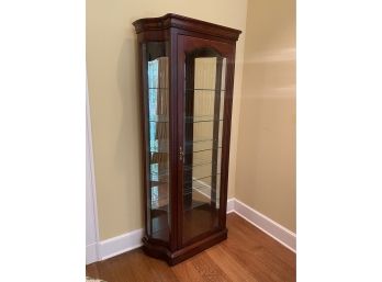 A Colonial Cherry Single Door Lighted Curio Cabinet With Five Glass Shelves By Jasper Cabinet Co