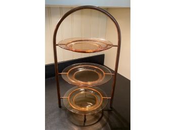 A Three Tier Metal And Glass Muffin Stand