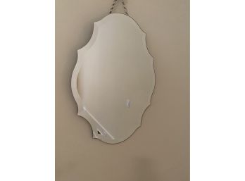 A Beveled Scalloped Wall Mirror With Chain And Glass Hanging Knob