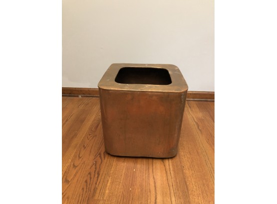 A Large Copper Planter Or Inverted Can Be A Table