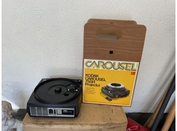 A VINTAGE SLIDE PROJECTOR WITH BOX