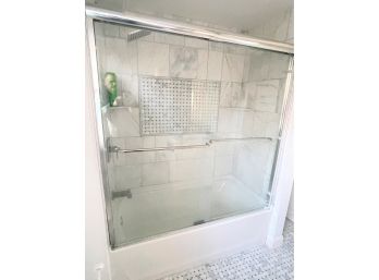 A Glass Shower Enclosure With Corner Shelves & Towel Bars
