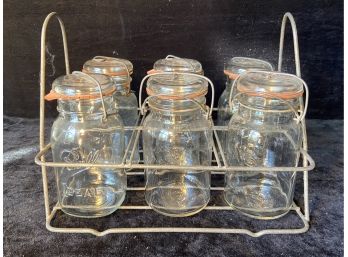Six Ball Ideal And Atlas E-Z Seal Jars In A Wire Basket
