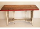 Vintage Wooden Table With A Curvaceous Wicker Base