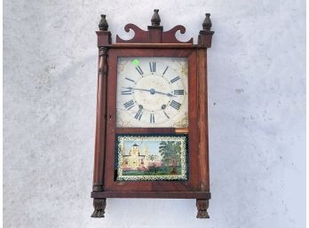 An Antique Clock With Reverse Glass Panel