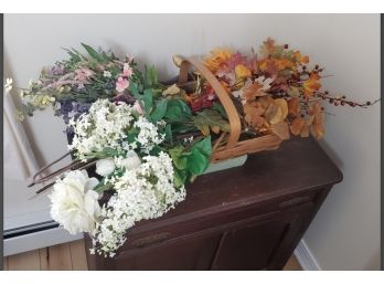 Handled Basket Full Of Three Colorful Bunches Of Imitation Flowers