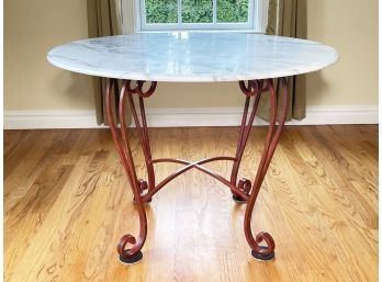 A Marble Top Dining Table With Wrought Iron Base