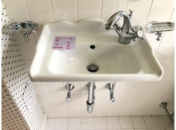 A Charming Tiny Porcelain Sink With Chrome Hardware