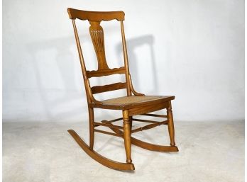 A Vintage Maple Cane Seated Rocking Chair
