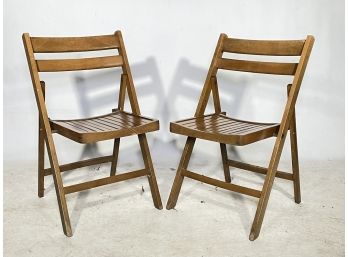 A Pair Of Slatted Wood Folding Chairs