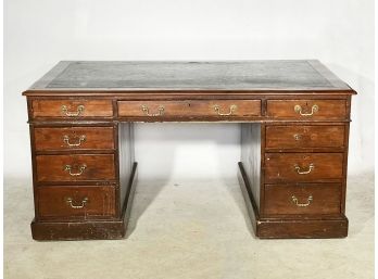 An Antique Leather Top Kneehole Desk