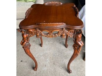 A Vintage Carved Wood Occasional Table With Cherub Motif On Legs