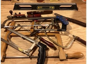 Group Of Various Tools Including Saws And A Level