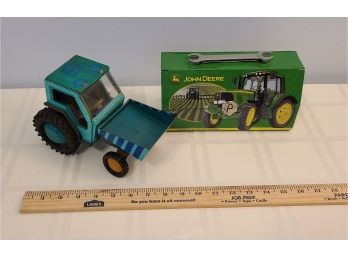 An Old Metal Tractor Toy And A Small Metal John Deere Tool Box