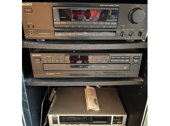 A Stereo Cabinet With Stereo Equipment - Sony And JVC