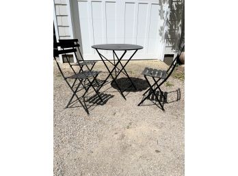 A Parisian Folding Metal Table And 3 Folding Chairs