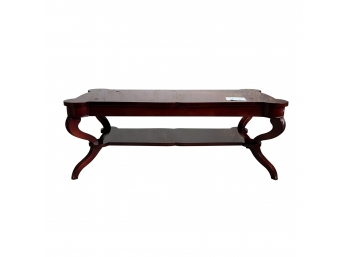 A 2 Tier Cherry Stain Coffee Table With Bowed Legs And Glass Top