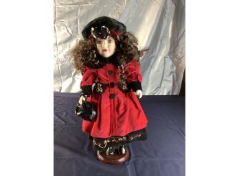 Porcelain Doll In Red Coat With Black Hat